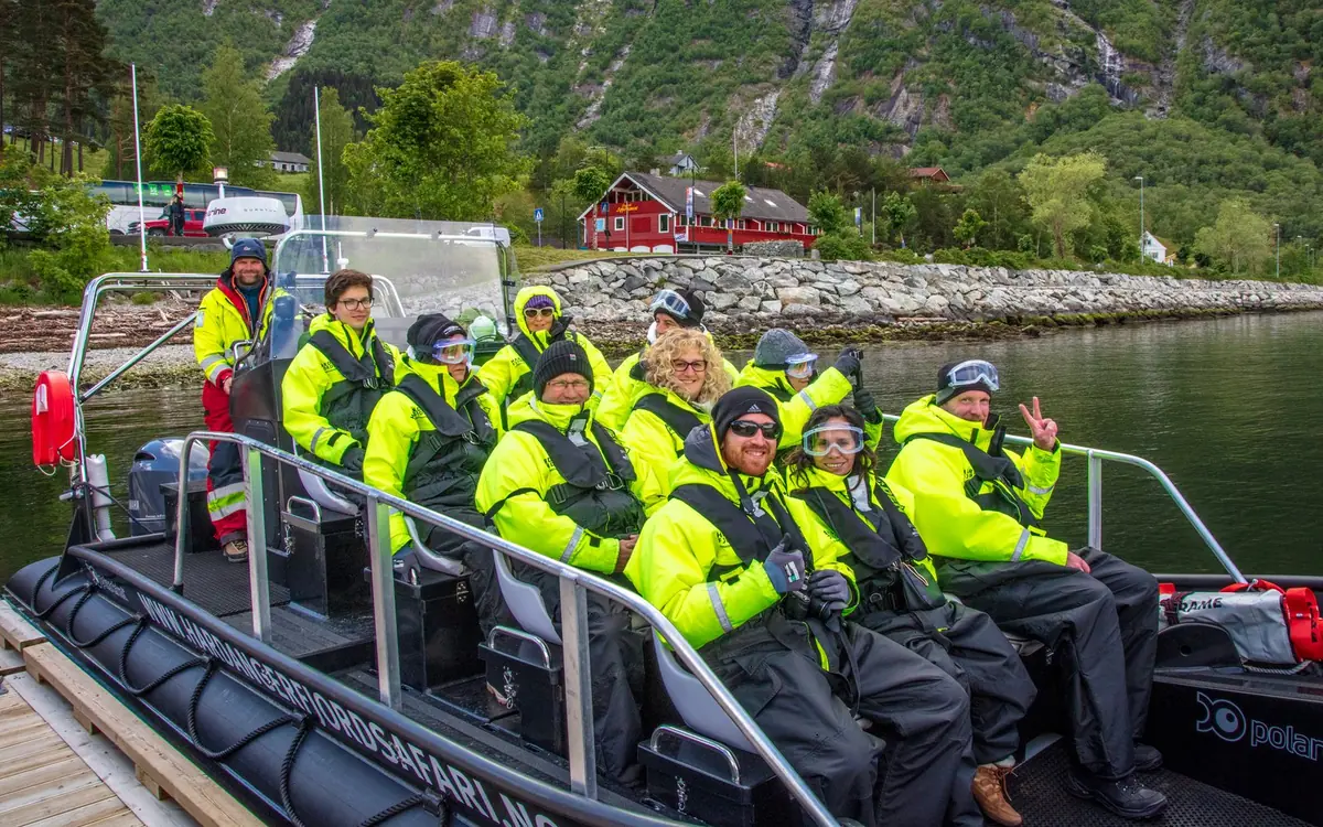 Passengers in survival suits on a RIB on the Hardangerfjord