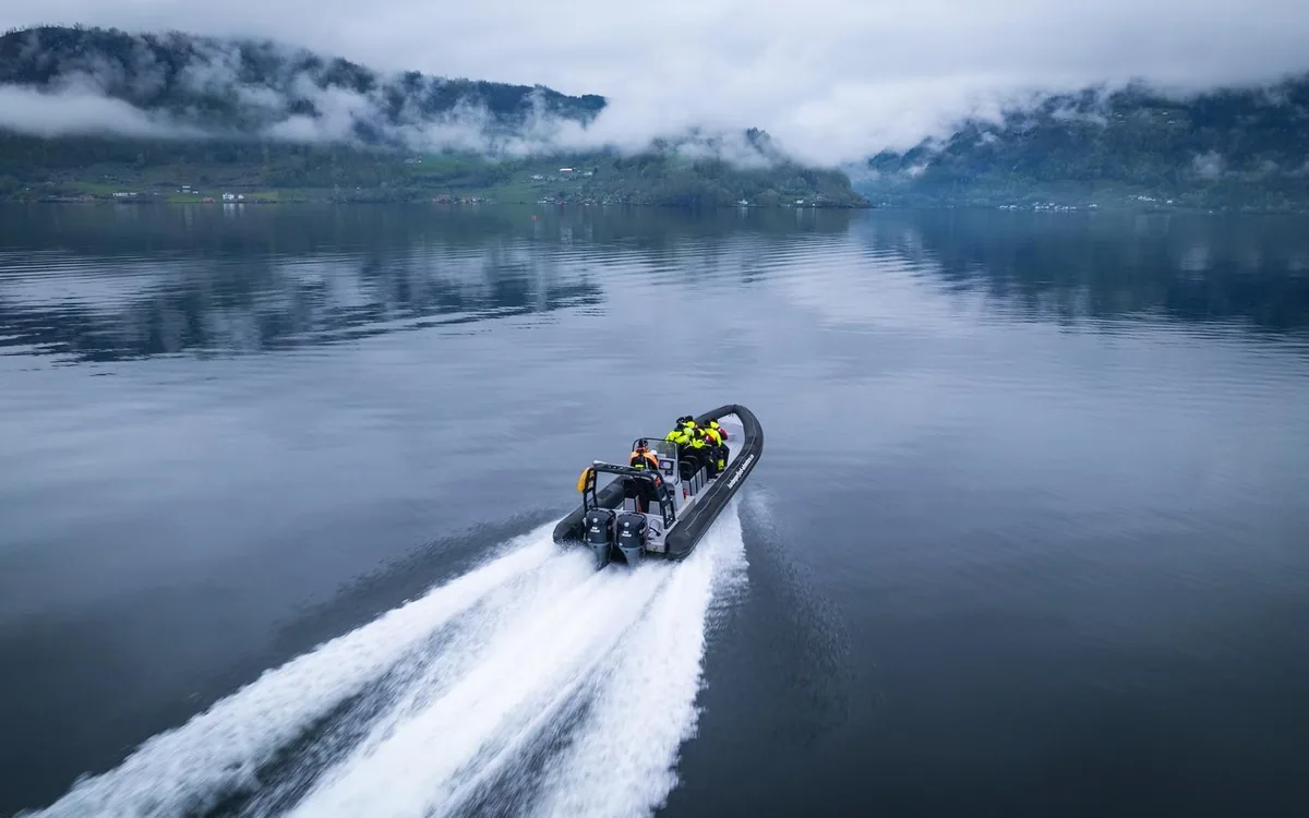 A RIB boat at speed in a narrow arm of the Hardangerfjord